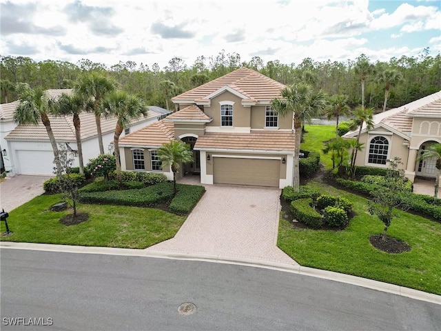 view of front facade featuring a front yard and a garage