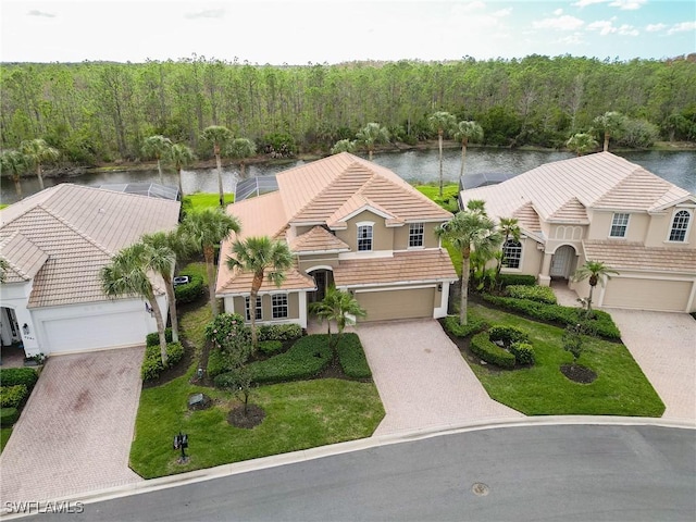 exterior space featuring a garage and a water view