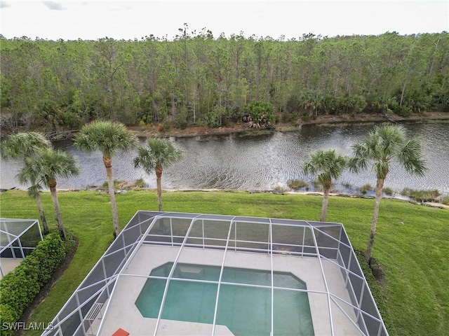 view of pool featuring glass enclosure, a yard, and a water view