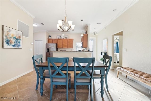 20680 Vita Ct, Venice, FL 34293 - dining room with a chandelier, crown molding, and light tile patterned floors