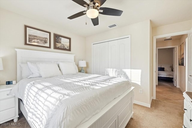 20680 Vita Ct, Venice, FL 34293 - bedroom with light carpet, a closet, and a ceiling fan