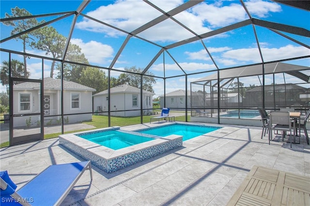 view of swimming pool with a lawn, glass enclosure, an in ground hot tub, and a patio