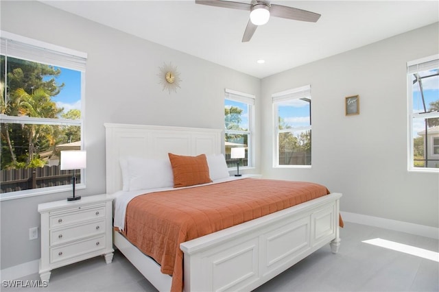 bedroom with ceiling fan and multiple windows