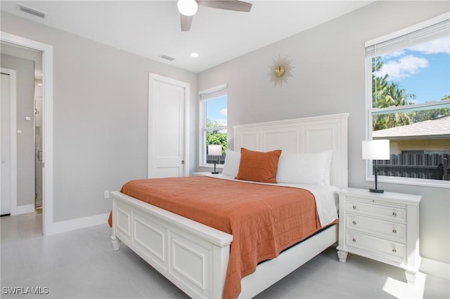 bedroom featuring multiple windows and ceiling fan