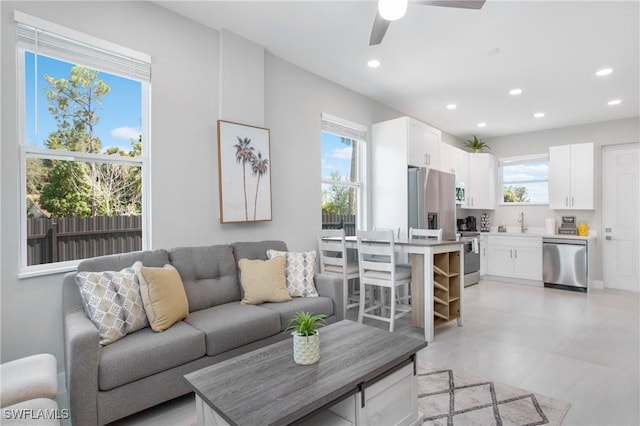 living room with ceiling fan and sink