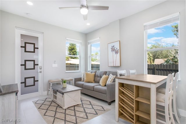 living room featuring ceiling fan and a healthy amount of sunlight