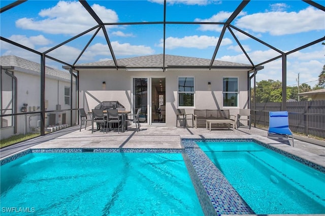 view of pool with a lanai and a patio area