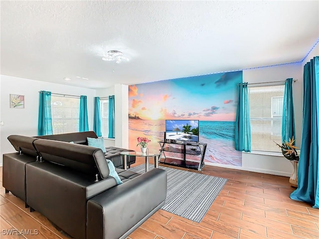 living room with a textured ceiling and light wood-type flooring