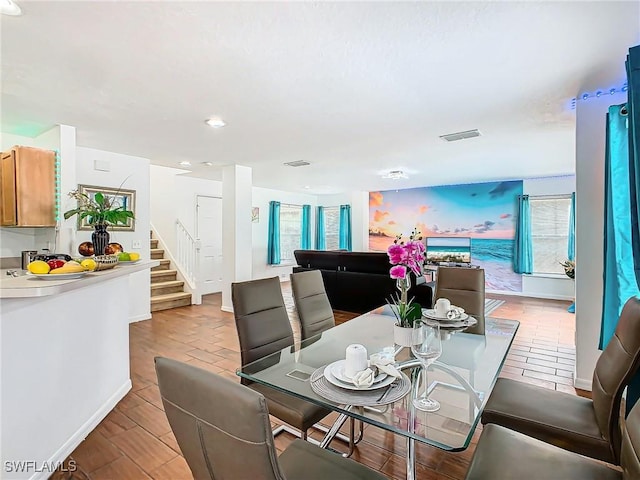 dining space with light hardwood / wood-style floors