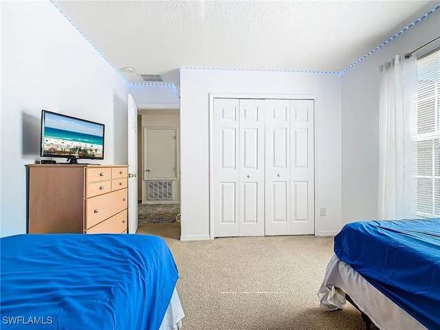 carpeted bedroom featuring a closet