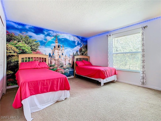 bedroom with carpet floors and a textured ceiling