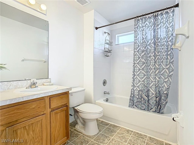 full bathroom featuring tile patterned floors, shower / bath combo with shower curtain, vanity, and toilet