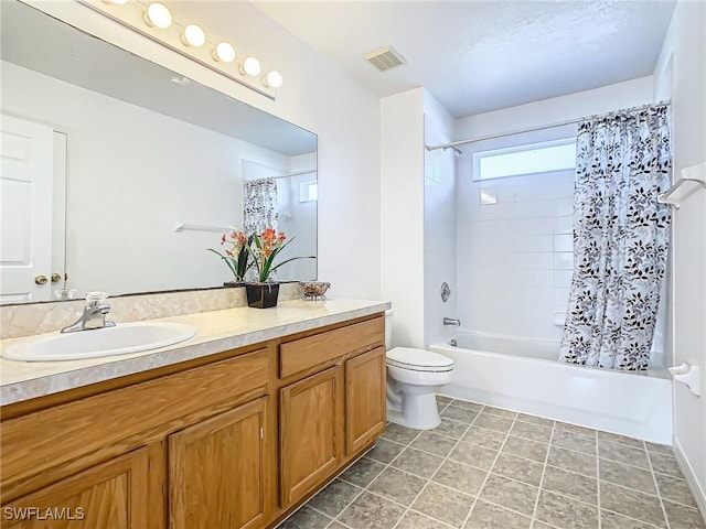 full bathroom featuring tile patterned floors, shower / tub combo with curtain, vanity, and toilet