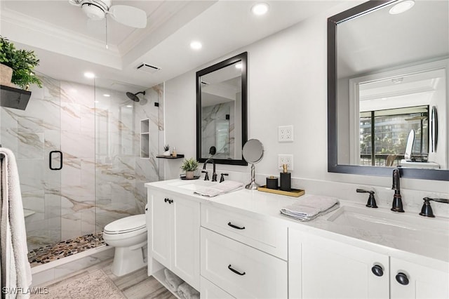 bathroom with vanity, crown molding, ceiling fan, toilet, and walk in shower