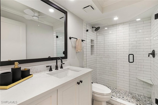 bathroom featuring vanity, toilet, a shower with door, and ceiling fan