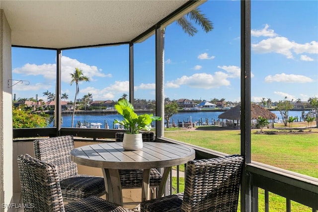 sunroom / solarium with a water view