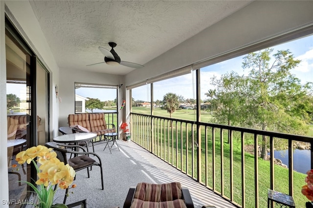 unfurnished sunroom featuring ceiling fan and a healthy amount of sunlight