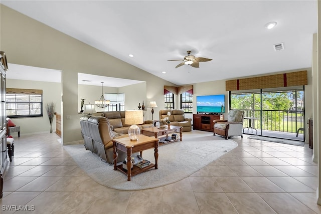 living room with ceiling fan with notable chandelier, light tile patterned floors, and lofted ceiling