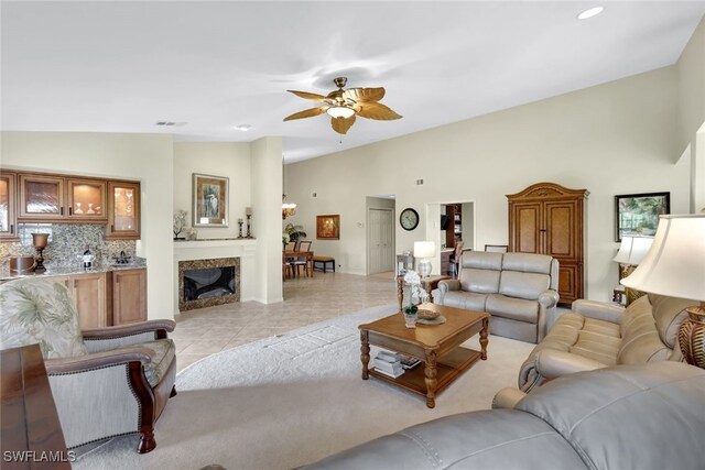 tiled living room featuring vaulted ceiling and ceiling fan