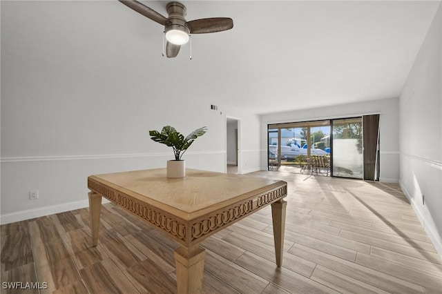 interior space with light wood-type flooring and ceiling fan