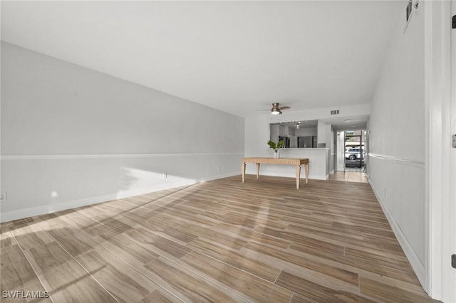 unfurnished living room featuring ceiling fan