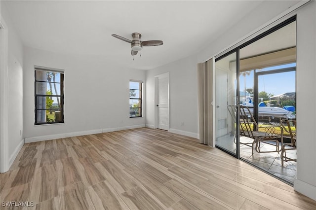 empty room with light hardwood / wood-style floors and ceiling fan