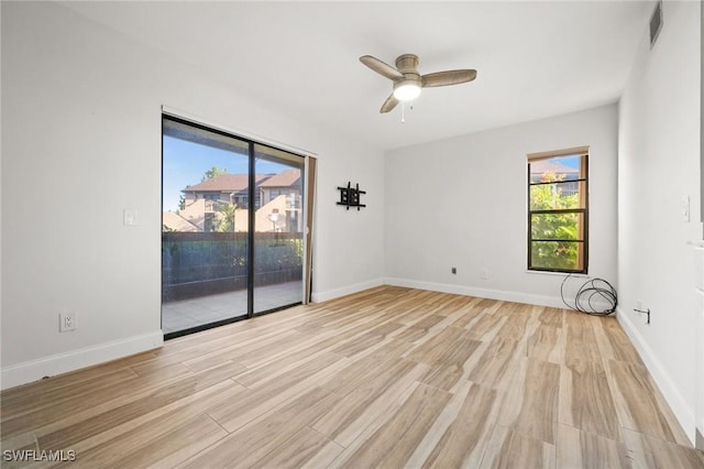 spare room with light hardwood / wood-style floors and ceiling fan