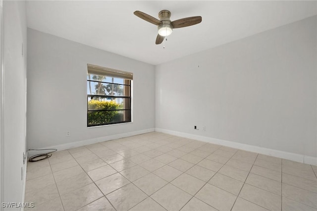 tiled spare room featuring ceiling fan