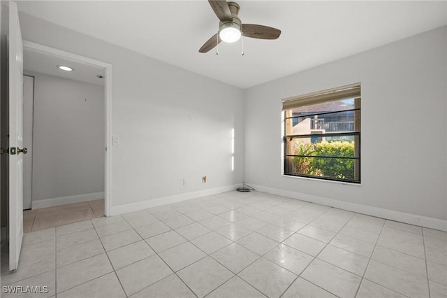 spare room featuring light tile patterned floors and ceiling fan