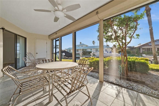 sunroom featuring ceiling fan and a healthy amount of sunlight