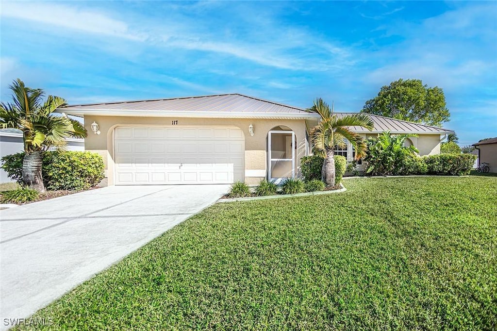 ranch-style house featuring a garage and a front lawn