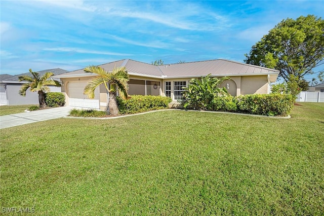 ranch-style house featuring a front yard and a garage