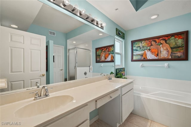 bathroom with a garden tub, visible vents, and a sink