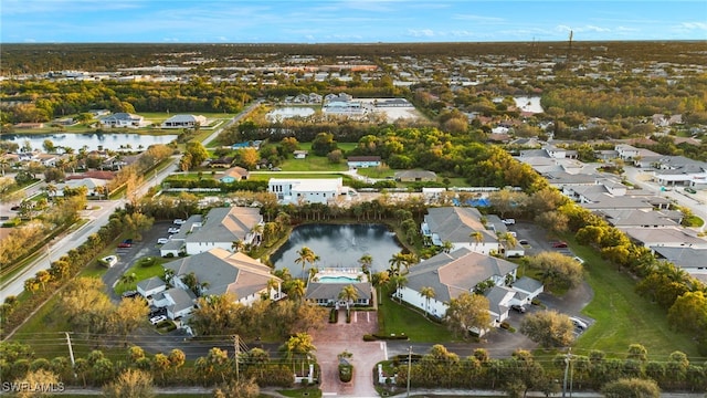 birds eye view of property featuring a water view and a residential view