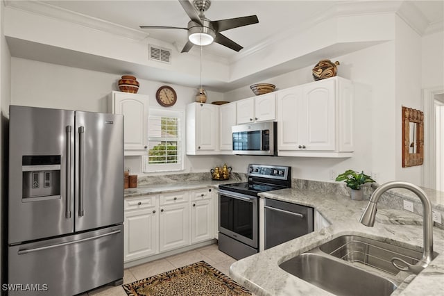 kitchen featuring visible vents, appliances with stainless steel finishes, a sink, and ornamental molding