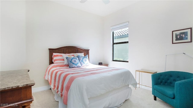 bedroom featuring light colored carpet and ceiling fan