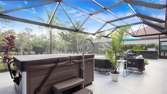 view of patio / terrace featuring glass enclosure and a hot tub