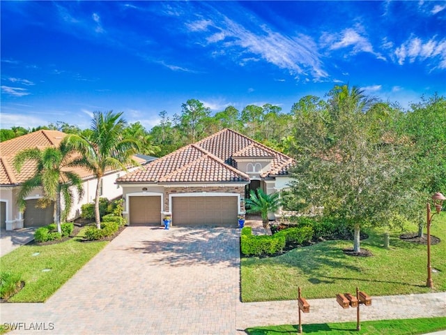 mediterranean / spanish-style house with a garage and a front yard