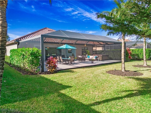 rear view of property with glass enclosure, a patio area, a yard, and an outdoor hangout area