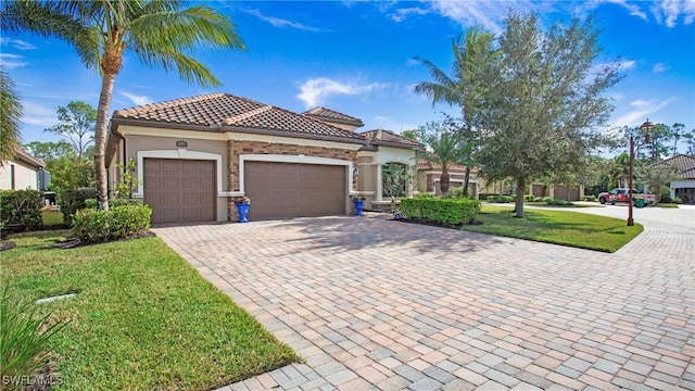 mediterranean / spanish-style house with a front yard and a garage