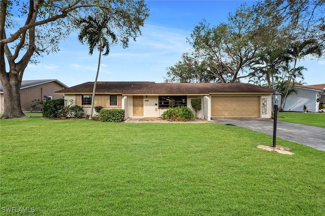 single story home with a garage and a front lawn