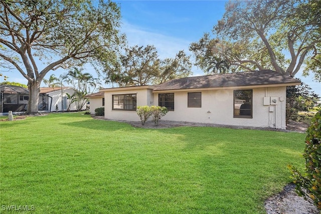 rear view of house with a yard