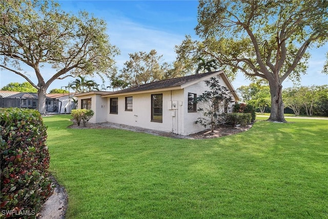 rear view of house with a yard