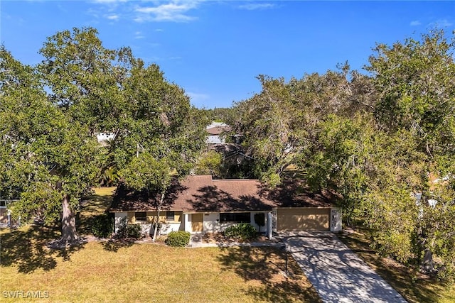 view of front of house featuring a garage and a front lawn