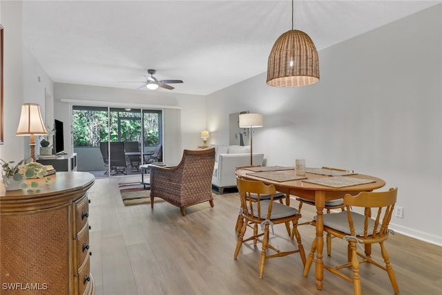 dining space featuring light hardwood / wood-style floors and ceiling fan