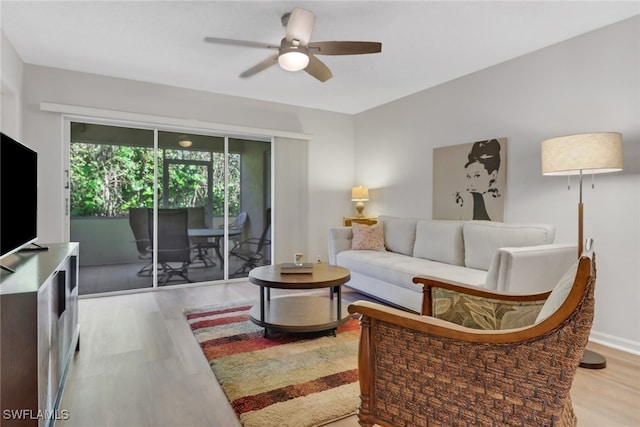 living room featuring light hardwood / wood-style flooring and ceiling fan