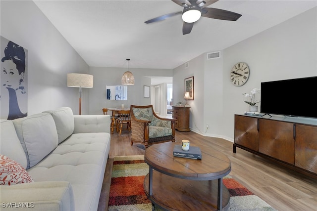 living room featuring ceiling fan and light hardwood / wood-style flooring