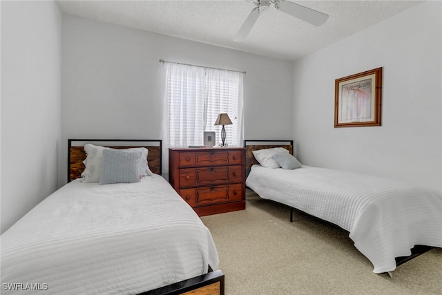 bedroom with carpet flooring, ceiling fan, and a textured ceiling