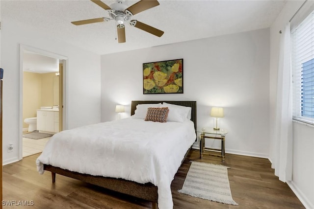 bedroom featuring hardwood / wood-style floors, ceiling fan, ensuite bathroom, and a textured ceiling