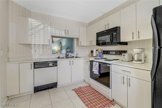 kitchen featuring white cabinets, sink, light tile patterned flooring, and black appliances